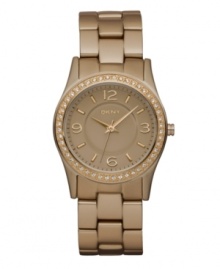Hints of caramel shine on this mini watch by DKNY. Rose-gold tone aluminum bracelet and round rose-gold aluminum-plated stainless steel case. Bezel embellished with crystal accents. Rose-gold tone dial features applied rose-gold tone numerals at twelve, three, six and nine o'clock, stick indices, minute track, three hands and logo. Quartz movement. Water resistant to 50 meters. Two-year limited warranty. Hints of caramel shine on this mini watch by DKNY. Rose-gold tone aluminum bracelet and round rose-gold aluminum-plated stainless steel case. Bezel embellished with crystal accents. Rose-gold tone dial features applied rose-gold tone numerals at twelve, three, six and nine o'clock, stick indices, minute track, three hands and logo. Quartz movement. Water resistant to 50 meters. Two-year limited warranty.