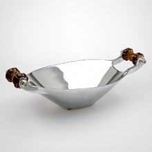This hand-crafted bowl features dark amber glass handles with exquisitely hand-polished metal. This hand-crafted bowl features dark amber glass handles with exquisitely hand-polished metal.