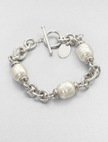 Three beautiful pearl stations on a rhodium-plated stainless steel chain link design. 12mm organic white baroque man-made pearlRhodium-plated stainless steelLength, about 7.5Toggle closureImported Three beautiful pearl stations on a rhodium-plated stainless steel chain link design. 12mm organic white baroque man-made pearlRhodium-plated stainless steelLength, about 7.5Toggle closureImported