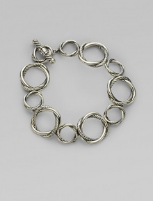 From the Infinity Collection. Graceful, graduated circles, each formed of interwoven strands of smooth and cabled sterling silver, connect to form an elegant bracelet. Sterling silver Length, about 7½ Toggle closure Imported From the Infinity Collection. Graceful, graduated circles, each formed of interwoven strands of smooth and cabled sterling silver, connect to form an elegant bracelet. Sterling silver Length, about 7½ Toggle closure Imported