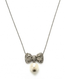 Sparkling and stylish. Betsey Johnson's bow and glass pearl pendant necklace will add plenty of panache to your look. Crafted in hematite tone mixed metal, it's adorned with dazzling crystal details. Approximate length: 16 inches + 3-inch extender. Approximate drop: 1 inch. Sparkling and stylish. Betsey Johnson's bow and glass pearl pendant necklace will add plenty of panache to your look. Crafted in hematite tone mixed metal, it's adorned with dazzling crystal details. Approximate length: 16 inches + 3-inch extender. Approximate drop: 1 inch.