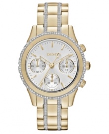 Golden shine and swirling rings of crystal accents prettify this timeless steel watch from DKNY. Golden shine and swirling rings of crystal accents prettify this timeless steel watch from DKNY.