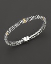 Sterling silver Caviar™ beaded oval rope bracelet with five gold stations with logo box clasp closure. Designed by Lagos.
