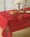 With a rich red hue and daintily scalloped edges, this round tablecloth puts a festive, feminine touch on wintertime tables. Swirling ribbons and sprigs of holly set the scene for delectable Christmas dining.