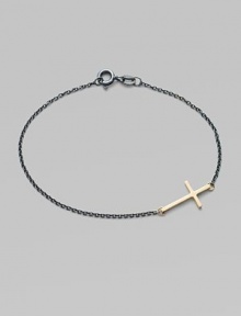 A gleaming 14k gold cross on an oxidized sterling silver chain.14k yellow gold Oxidized sterling silver Length, about 7 Pendant length, about ¾ Spring ring clasp Made in USA A gleaming 14k gold cross on an oxidized sterling silver chain.14k yellow gold Oxidized sterling silver Length, about 7 Pendant length, about ¾ Spring ring clasp Made in USA