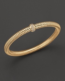 A row of diamonds binds this woven 18K yellow gold bracelet from Roberto Coin. A row of diamonds binds this woven 18K yellow gold bracelet from Roberto Coin.