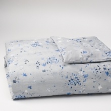 Freshly painted flowers in tones of blue fall on a textured ground. Duvet has a hidden button closure. Duvets and shams are self reversing. Freshly painted flowers in tones of blue fall on a textured ground. Duvet has a hidden button closure. Duvets and shams are self reversing.