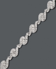 Have her unwrap the perfect gift this season. This stunning tennis bracelet by Wrapped in Love(tm) features three sleek rows of round-cut diamonds (1 ct. t.w.) set in 14k white gold. Approximate length: 7-1/4 inches. Have her unwrap the perfect gift this season. This stunning tennis bracelet by Wrapped in Love(tm) features three sleek rows of round-cut diamonds (1 ct. t.w.) set in 14k white gold. Approximate length: 7-1/4 inches.