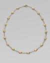 From the Siviglia Collection. Textured oval beads of 18k gold, delicately attached by gold chains. 18k yellow gold Length, about 16 Lobster clasp Made in Italy