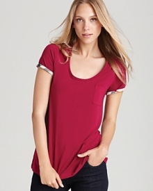 A vibrant jewel tone elevates your classic Burberry Brit tee shirt, while check lining lends an unexpected pop of pattern to the wardrobe essential. A vibrant jewel tone elevates your classic Burberry Brit tee shirt, while check lining lends an unexpected pop of pattern to the wardrobe essential.