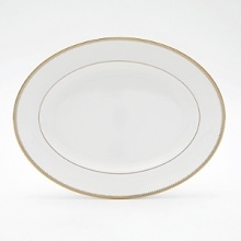Rings of gold adorn fine white bone china with the lustrous shine of a wedding band. White bone china features two different border trims of gold, a wide corded border of textured grosgrain ribbon on some pieces, a narrow edge on others. Rings of gold adorn fine white bone china with the lustrous shine of a wedding band. White bone china features two different border trims of gold, a wide corded border of textured grosgrain ribbon on some pieces, a narrow edge on others.