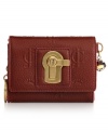 Inspired by the past while feeling fresh and modern, this signature-embossed leather design from Juicy Couture is the ultimate accessory. Antique golden hardware features a charming turnlock closure that lends a distinctly vintage feel, while the interior zip compartment keeps cards, cash and ID safe and secure.