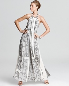A geometric print lends modernity to the flowing silhouette of this BCBGMAXMAZRIA gown, designed with a halter neckline, draped front panel and exposed scoop back. Dramatic and daring, this piece was made for appearances. A geometric print lends modernity to the flowing silhouette of this BCBGMAXMAZRIA gown, designed with a halter neckline, draped front panel and exposed scoop back. Dramatic and daring, this piece was made for appearances.