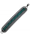 Emerald city sophistication. This GUESS bracelet displays baguette-cut emerald crystals on a trendy four-row design. Crafted in hematite tone mixed metal. Approximate length: 7-1/2 inches.