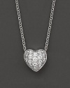 A diamond pavé heart necklace. With signature ruby accent. Designed by Roberto Coin.
