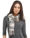 Luxuriously soft cashmere scarf in an all over check pattern is finished with fringe trim.