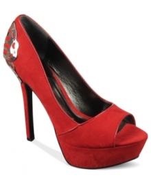 A metal butterfly decal adorns the back of the Sexy Too platform pumps by Carlos by Carlos Santana, creating a look that's truly transformative. A metal butterfly decal adorns the back of the Sexy Too platform pumps by Carlos by Carlos Santana, creating a look that's truly transformative.