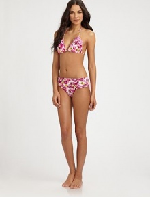 A classic style complemented by a pretty floral print.Triangle cupsHalter strap ties at neckBack tie closure87% nylon/13% spandexFully linedHand washImported Please note: Bikini bottom sold separately. A classic style complemented by a pretty floral print.Triangle cupsHalter strap ties at neckBack tie closure87% nylon/13% spandexFully linedHand washImported Please note: Bikini bottom sold separately.