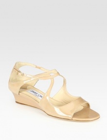 Patent leather wedge with adjustable, curvy straps adds the perfect finishing touch to any outfit. Self-covered wedge, 1½ (40mm)Patent leather upperLeather lining and solePadded insoleMade in Italy Patent leather wedge with adjustable, curvy straps adds the perfect finishing touch to any outfit. Self-covered wedge, 1½ (40mm)Patent leather upperLeather lining and solePadded insoleMade in Italy