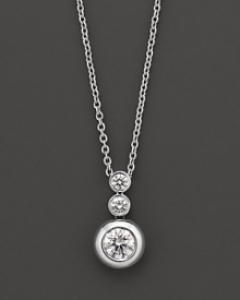 White gold bezel-set diamond necklace in three-stone drop design. With signature ruby accent. Designed by Roberto Coin. White gold bezel-set diamond necklace in three-stone drop design. With signature ruby accent. Designed by Roberto Coin.