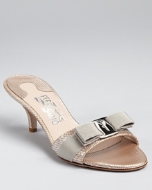 In textured, metallic leather, Salvatore Ferragamo's Glory sandals feel modern yet refined. A moderate mid-heel adds practicality while the brand's signature grosgrain bow adds a final feminine touch. In textured, metallic leather, Salvatore Ferragamo's Glory sandals feel modern yet refined. A moderate mid-heel adds practicality while the brand's signature grosgrain bow adds a final feminine touch.