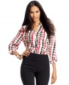 Style&co. revamps classic houndstooth in bold hues and an exaggerated print for this button-front petite shirt.