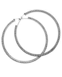 Sparkling and stylish. Large hoop earrings are always a casually chic choice, but GUESS' version goes glam with glittering glass accents. Set in hematite tone mixed metal. Approximate diameter: 2-1/4 inches. Sparkling and stylish. Large hoop earrings are always a casually chic choice, but GUESS' version goes glam with glittering glass accents. Set in hematite tone mixed metal. Approximate diameter: 2-1/4 inches.