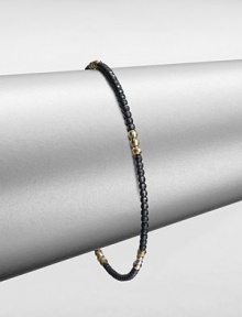 A simple chic piece that features faceted beads in blackened sterling silver accented with five, 14k gold beaded sections. Blackened sterling silver14k goldDiameter, about 2.5Slip-on styleMade in USA A simple chic piece that features faceted beads in blackened sterling silver accented with five, 14k gold beaded sections. Blackened sterling silver14k goldDiameter, about 2.5Slip-on styleMade in USA