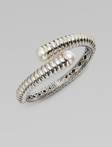 From the Bedeg Collection. A richly ribbed hinged cuff of gleaming sterling silver with accents of 18k gold has overlapping endcaps set with lustrous pearls.White pearlsSterling silver and 18k yellow goldDiameter, about 2¼Width, about ½HingedImported From the Bedeg Collection. A richly ribbed hinged cuff of gleaming sterling silver with accents of 18k gold has overlapping endcaps set with lustrous pearls.White pearlsSterling silver and 18k yellow goldDiameter, about 2¼Width, about ½HingedImported