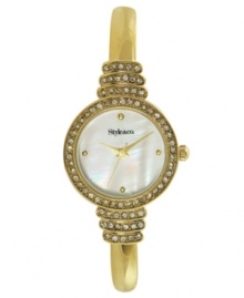 Put your best foot forward with this gleaming watch by Style&co. Gold tone mixed metal bangle bracelet and round case with crystal-accented link. Bezel embellished with crystal accents. Mother-of-pearl dial features four gold tone dot markers, three hands and logo. Quartz movement. Two-year limited warranty. Put your best foot forward with this gleaming watch by Style&co. Gold tone mixed metal bangle bracelet and round case with crystal-accented link. Bezel embellished with crystal accents. Mother-of-pearl dial features four gold tone dot markers, three hands and logo. Quartz movement. Two-year limited warranty.