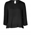 A fashionably boxier cut and a fail-safe hue lend this Tara Jarmon black silk top its easy elegance - Lightweight and especially flattering, thanks to a generous touch of stretch - Relaxed silhouette tapers gently through middle - Round neckline and 3/4 sleeves - Single-button closure and key hole detail at nape of neck - Fluid and feminine, seamlessly transitions from the office to evenings out - Pair with with cigarette pants, pencil skirts or leather leggings