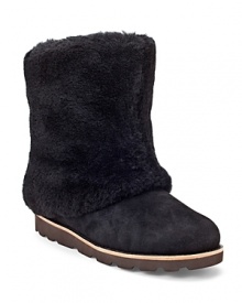 These fuzzy boots show off UGG® Australia's cozy-cool shearling style. These fuzzy boots show off UGG® Australia's cozy-cool shearling style.