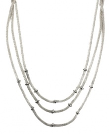 Add just the right amount of layers to amp up your look. AK Anne Klein necklace features three rows of woven chains accented by donut-shaped beads. Crafted in silver tone mixed metal. Approximate length: 16 inches. Add just the right amount of layers to amp up your look. AK Anne Klein necklace features three rows of woven chains accented by donut-shaped beads. Crafted in silver tone mixed metal. Approximate length: 16 inches.