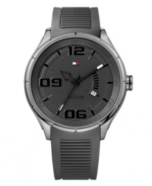 Stylish sport watch that will have you on trend while in the gym, by Tommy Hilfiger. Watch crafted of gray ribbed silicone strap and round stainless steel case. Gray dial features numerals at six, nine and twelve o'clock, applied stick indices, date window at four o'clock, three hands and iconic flag logo at twelve o'clock. Quartz movement. Water resistant to 50 meters. Ten-year limited warranty.