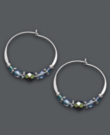 Multi-faceted style. Jody Coyote's unique hoop earrings get an updated look with the addition of faceted blue glass beads, seed beads, sterling silver beads and antique silver plated pewter beads. Set in sterling silver. Approximate diameter: 7/8 inch. Multi-faceted style. Jody Coyote's unique hoop earrings get an updated look with the addition of faceted blue glass beads, seed beads, sterling silver beads and antique silver plated pewter beads. Set in sterling silver. Approximate diameter: 7/8 inch.