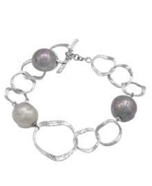 Hammered metal circles of sterling silver shine alongside multicolor iridescent, organic, man-made baroque pearls in this bracelet by Majorica. Approximate length: 7-1/4 inches. Hammered metal circles of sterling silver shine alongside multicolor iridescent, organic, man-made baroque pearls in this bracelet by Majorica. Approximate length: 7-1/4 inches.
