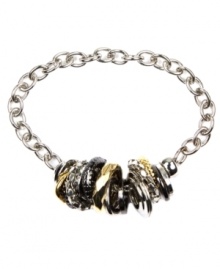 There's nothing more versatile than this chic, tri tone bracelet by Nine West. Featuring a trendy toggle clasp, bracelet highlights a cluster of disc charms in silver tone, gold tone, and hematite tone mixed metal. Approximate length: 7-1/4 inches.