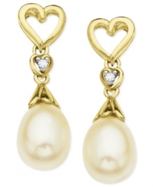 The look of love. A heart-shaped design, along with cultured freshwater pearls (6-8 mm) and diamond accents, helps make these earrings a pair to embrace. Crafted from 10k gold. Approximate drop: 3/4 inch.