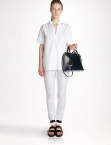 The ultimate in minimal elegance, this crisply tailored style is shaped with a subtle back pleat.Band collarShort sleevesOpen placketBack pleatCottonDry cleanMade in ItalyModel shown is 5'10 (177cm) wearing US size 4. The ultimate in minimal elegance, this crisply tailored style is shaped with a subtle back pleat.Band collarShort sleevesOpen placketBack pleatCottonDry cleanMade in ItalyModel shown is 5'10 (177cm) wearing US size 4.