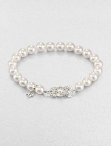 A lustrous strand of cultured pearls accented with a feminine 18k white gold clasp. 7mm-7.5mm round white cultured pearls18k white goldLength, about 7Butterfly closureImported A lustrous strand of cultured pearls accented with a feminine 18k white gold clasp. 7mm-7.5mm round white cultured pearls18k white goldLength, about 7Butterfly closureImported