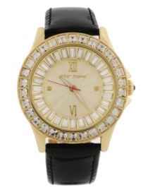 A classic boyfriend-style timepiece given a shot of glitzy glamour, by Betsey Johnson. Crafted of black leather strap and round gold tone stainless steel case. Bezel embellished with crystal accents. Textured champagne dial features ring of baguette-cut crystal accents, applied silver tone Roman numerals at twelve and six o'clock, dot markers at three and nine o'clock, luminous hour and minute hands, signature fuchsia second hand and logo at twelve o'clock. Quartz movement. Water resistant to 30 meters. Two-year limited warranty.