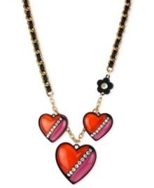 Hearts in the right place. Betsey Johnson's necklace is crafted from gold-tone mixed metal with black grosgrain ribbon. Three heart charms and a flower one, too, are adorned with glass crystal accents for a lustrous touch. Approximate length: 16 inches + 3-inch extender. Approximate drop: 1-3/4 inches. Hearts in the right place. Betsey Johnson's necklace is crafted from gold-tone mixed metal with black grosgrain ribbon. Three heart charms and a flower one, too, are adorned with glass crystal accents for a lustrous touch. Approximate length: 16 inches + 3-inch extender. Approximate drop: 1-3/4 inches.