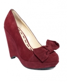 Sultry suede gets a sugary sweet accent on these Carlina platform wedges by Enzo Agiolini. An oversized bow ties across the chic almond-toe silhouette. Sultry suede gets a sugary sweet accent on these Carlina platform wedges by Enzo Agiolini. An oversized bow ties across the chic almond-toe silhouette.