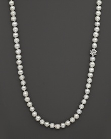 Pearl necklace finished with a white topaz and sterling silver flower ornament. By Anzie. Pearl necklace finished with a white topaz and sterling silver flower ornament. By Anzie.