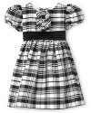 This classic Hartstrings holiday dress boasts a black and white plaid in rich shantung and luxurious touches like sparkly buttons and a charming back tie bow.