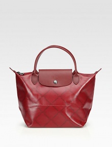 A glossy coated canvas style with signature logo print and leather accents, perfect for travel or everyday.Double leather top handles, 4½ dropTop zip closure with snap button flapOne inside open pocketCotton lining8¼W X 8¼H X 5½DImported A glossy coated canvas style with signature logo print and leather accents, perfect for travel or everyday.Double leather top handles, 4½ dropTop zip closure with snap button flapOne inside open pocketCotton lining8¼W X 8¼H X 5½DImported