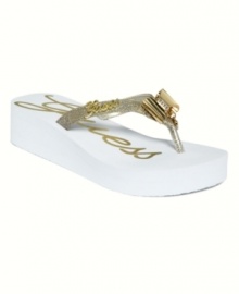 Absolutely fabulous. Glamour in the form of glitter, bows and charms spice up the beach-perfect Eagle thong sandals by GUESS. Absolutely fabulous. Glamour in the form of glitter, bows and charms spice up the beach-perfect Eagle thong sandals by GUESS.