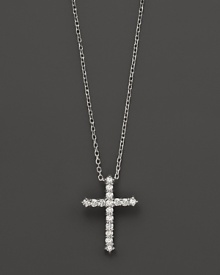 Diamonds, set in 14K white gold, form a chic cross. Diamonds, set in 14K white gold, form a chic cross.