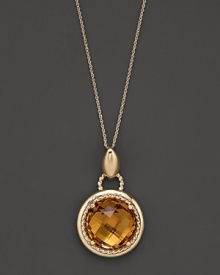 An expertly-rendered, faceted round citrine pendant set in 16 Kt. gold, with fine link chain. An expertly-rendered, faceted round citrine pendant set in 16 Kt. gold, with fine link chain.