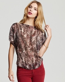Lend a hint of the exotic to the ensemble with this GUESS snake-print top, fashioned in an elegant, billowy silhouette. Lend a hint of the exotic to the ensemble with this GUESS snake-print top, fashioned in an elegant, billowy silhouette.